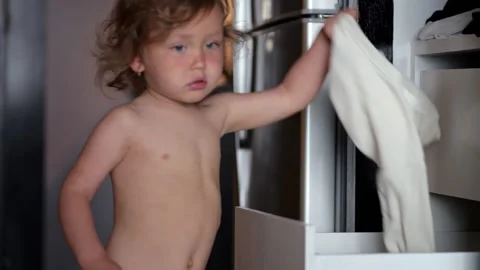 Curious child exploring closet and organizing clothes Video stock 302151002