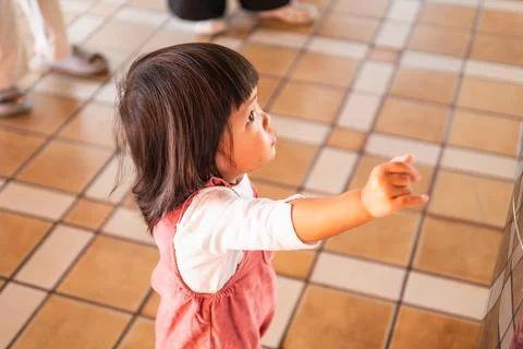 Curious child exploring indoor space play area candid bright environment cl.. Stock Photos