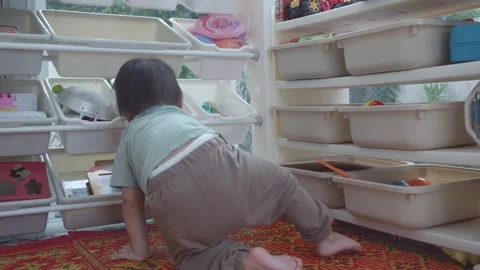 Curious Child Exploring Storage Bins Stock Footage 344032039