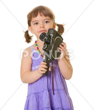 Curious child with an old movie camera Stock Photos