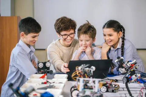 Curious children learn programming using laptops on extracurricular classes 写真素材