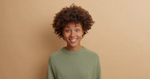 Curious dark skinned woman asks what and nods head with agreement says thats Stock Footage 142323796