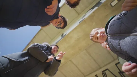 Curious family looking down into camera opening a box Stock Footage 327738811