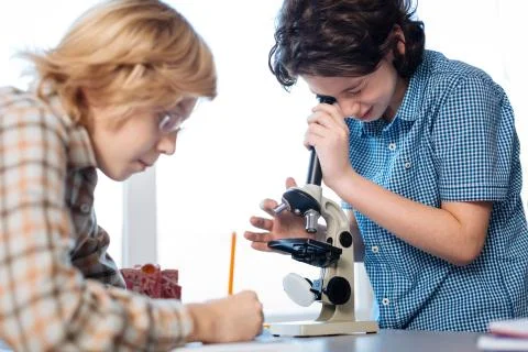 Curious future scientists exploring micro worlds Stock Photos