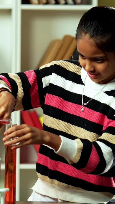 Curious Indian kids using a microscope and test tubes at school Stock-Footage 343214485
