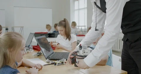 Curious kids working on a programable robot during robotics class at school Stock Footage 108873071