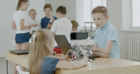 Curious kids working on a programable robot during robotics class at school Stock Footage 108878033