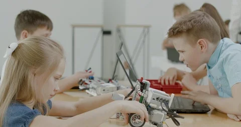 Curious kids working on a programable robot during robotics class at school Stock Footage 108878839