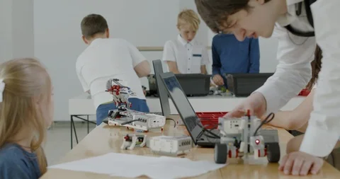 Curious kids working on a programable robot during robotics class at school Video stock 108881637