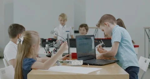 Curious kids working on a programable robot during robotics class at school Video stock 108883705