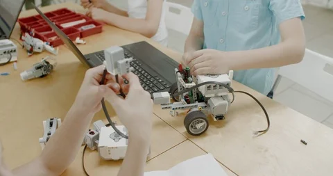 Curious kids working on a programable robot during robotics class at school Video stock 108888886
