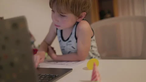 Curious little boy using a laptop computer Stock Footage 330198553