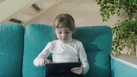 Curious Little Kid Girl Using Digital Pad Entertainment Device. Small Child Hold Stock Footage 210136601