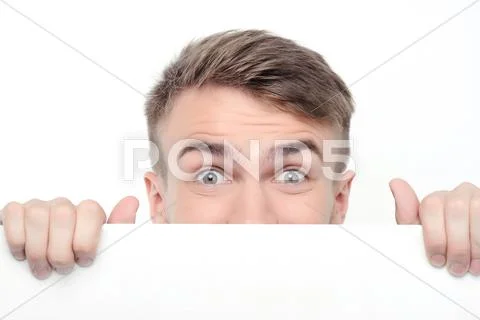 Curious man emerging from white board Stock Photos