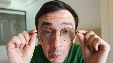 Curious man looking through glasses with shocked expression Video stock 337367215