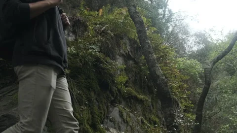 Curious man stops the hike to observe Stock Footage 243389770