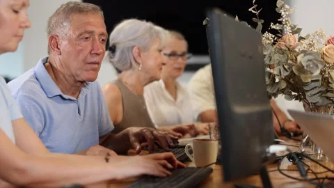 Curious mature man engaged in IT training during computer courses for adults Stock Footage 331310838