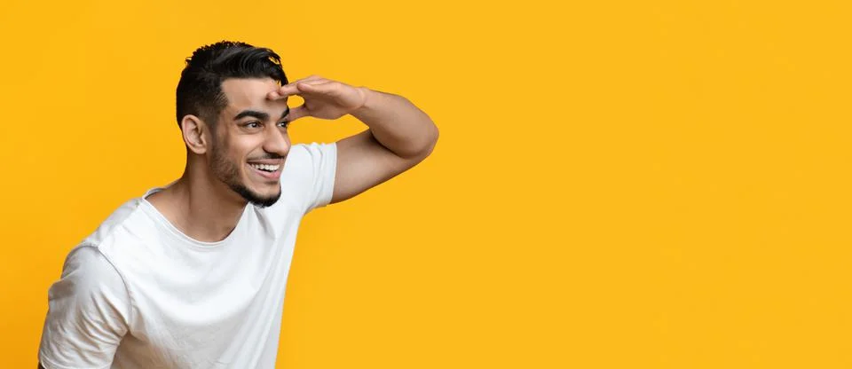 Curious middle-eastern guy smiling and looking at copy space Stock Photos