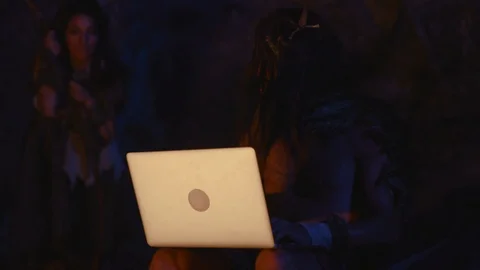 Curious prehistoric indigenous caveman using modern device portable computer in Video stock 116629326