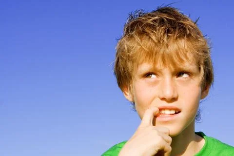 Curious, puzzled shy or scared kid or child finger in mouth Stock Photos