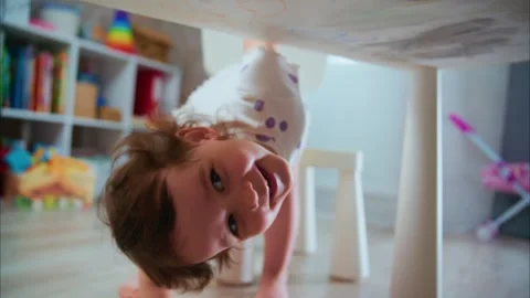 A Curious Toddler Engaging in Playful Creativity at Home, Exploring Artistic Stock Footage 315932059