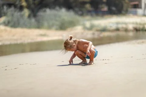 Curious Toddler Exploring Sandy Beach Stock Photos