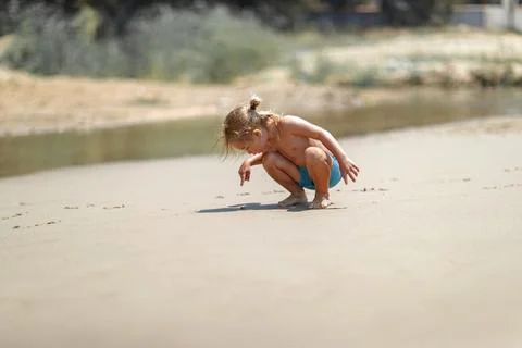 Curious Toddler Exploring Sandy Beach Stock Photos