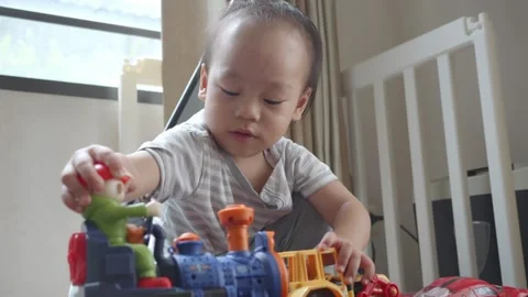 Curious Toddler Playing with Toy Vehicles on Treadmill Video stock 345662007