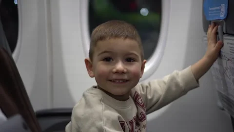 Curious toddler reaching beside a train window 動画素材 342069699