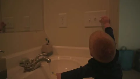 Curious Toddler Reaching for Light Switch curious toddler standing at bathroom Vídeo Stock 296088966