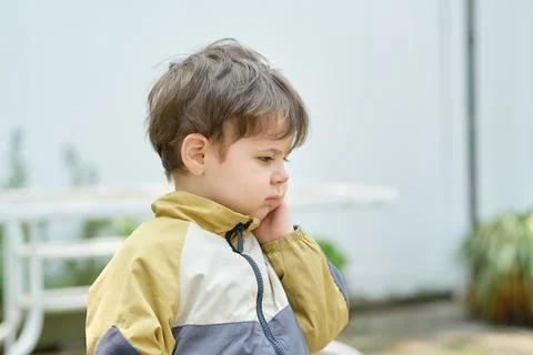Curious young boy exploring the backyard on a sunny day Fotos Stock