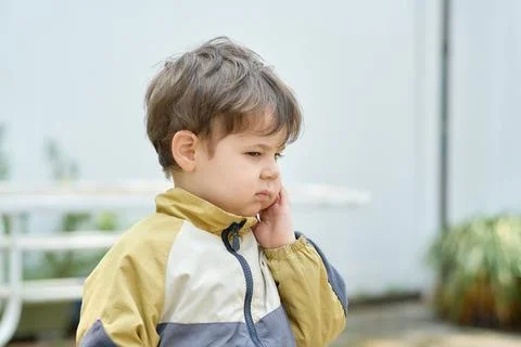 Curious young boy exploring the backyard on a sunny day Stock Photos