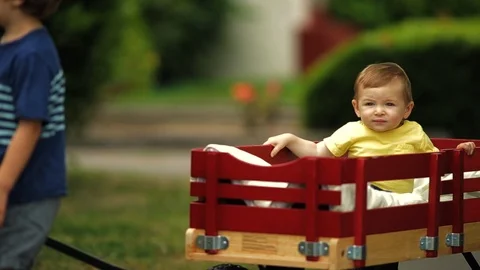 Curious young boy looking over a white picket fence. 스톡 동영상 88405417