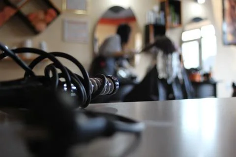Curling iron on the table Stock Photos