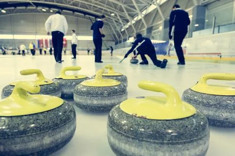 Curling stone on a game sheet Stock Photos