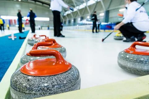 Curling stone on a game sheet Stock Photos