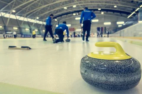 Curling stone on a game sheet. Stock Photos