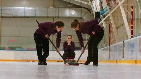 Curling training indoors - rubbing the ice before the biter Stock Footage 124184025