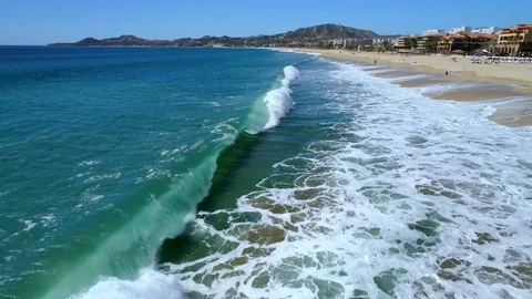 Curling Wave by sandy beach Stock Footage 124686414