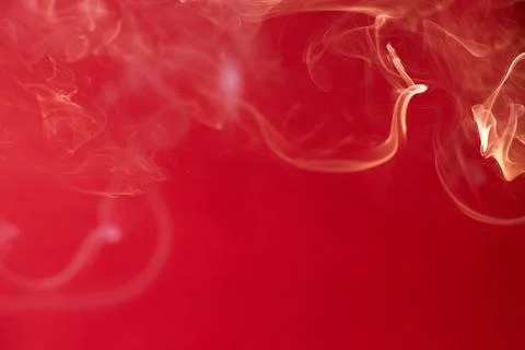 Curls of smoke on a red background Stock Photos