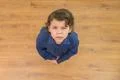 The curly boy look to the camera. View from above Photo