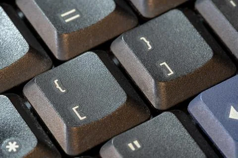 Curly brackets and square brackets, bracket symbol keys on a black computer.. Stockfoto's