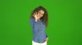 The curly businesswoman gesture ok and stand on the green background. Real time 4k or 4k+ Resolution