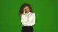 The curly businesswoman get an idea and stand on the green background. Real time 4k or 4k+ Resolution