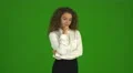 The curly businesswoman get an idea and stand on the green background. Real time 4k or 4k+ Resolution