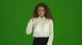 The curly businesswoman thumb down and stand on the green background. Real time 4k or 4k+ Resolution
