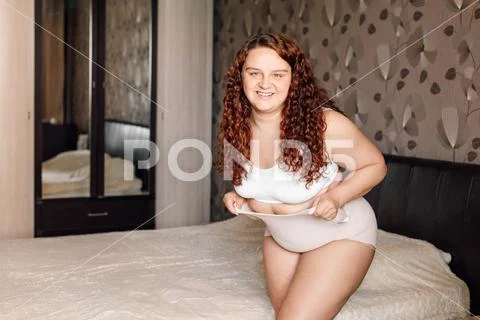 Premium Photo  Curly overweight woman in white underwear stand
