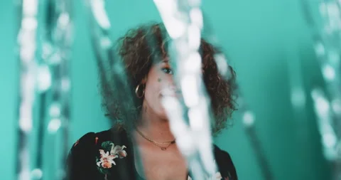 Curly girls dancing through a glitter curtain. Video stock 204969448
