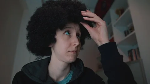 Curly haired, Afro head white woman is playing her hair.  Stock Footage 108250580