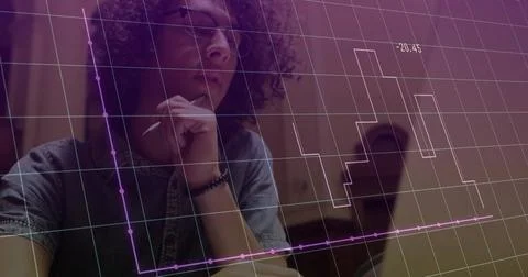Curly-haired analyst with eyeglasses studying data charts at office with laptop, Stock Photos